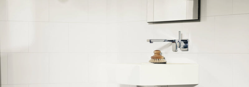 A sleek chrome wall-mounted faucet with minimalist design from the bilbao collection above a white sink