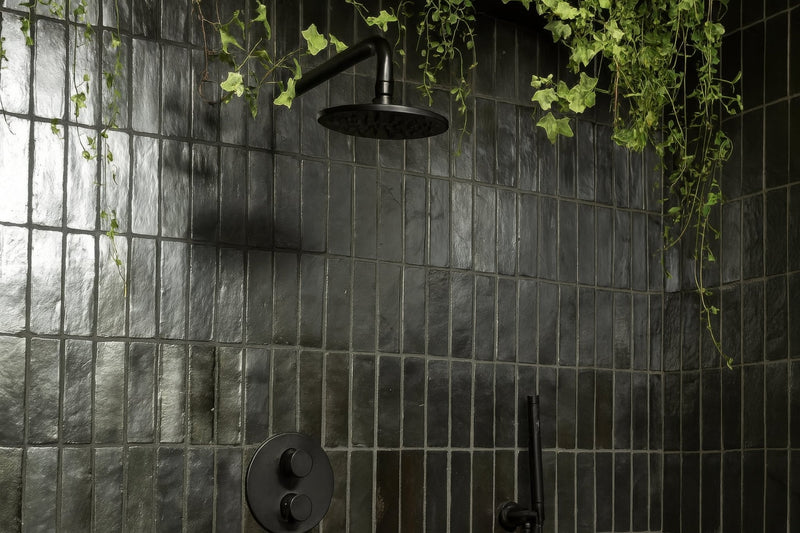 Black matte finished showerhead with sleek modern design in black bathroom tiles collection