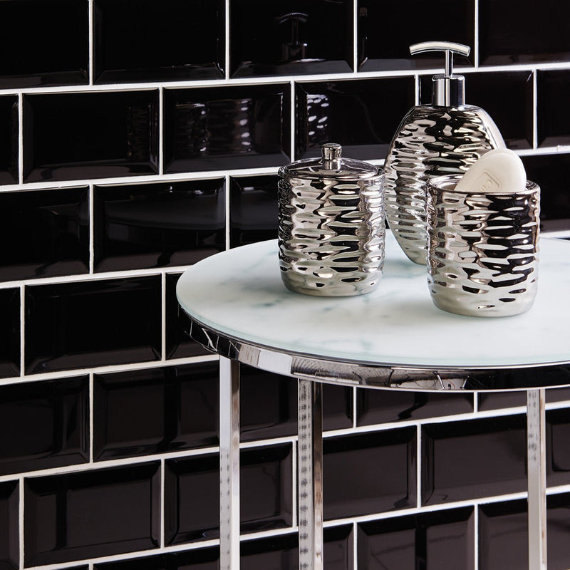 Silver textured bathroom accessory set with wavy pattern from black tiles collection