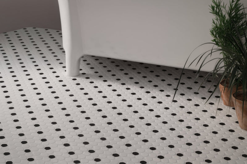White hexagonal floor tiles with black circular accents for stylish black and white bathroom tile design
