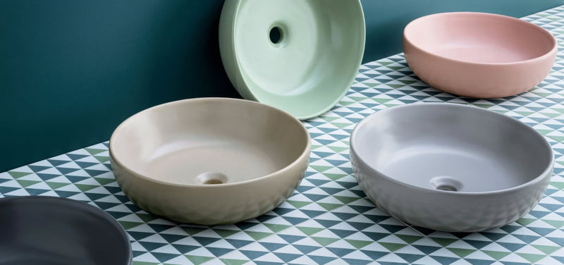 Set of modern ceramic bathroom sinks in soft pastel and neutral tones with a subtle textured finish