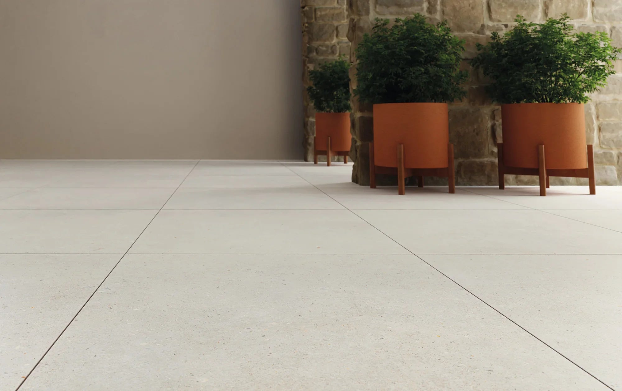 Terracotta planters with wooden legs in the brera collection showcasing earthy tones and modern design