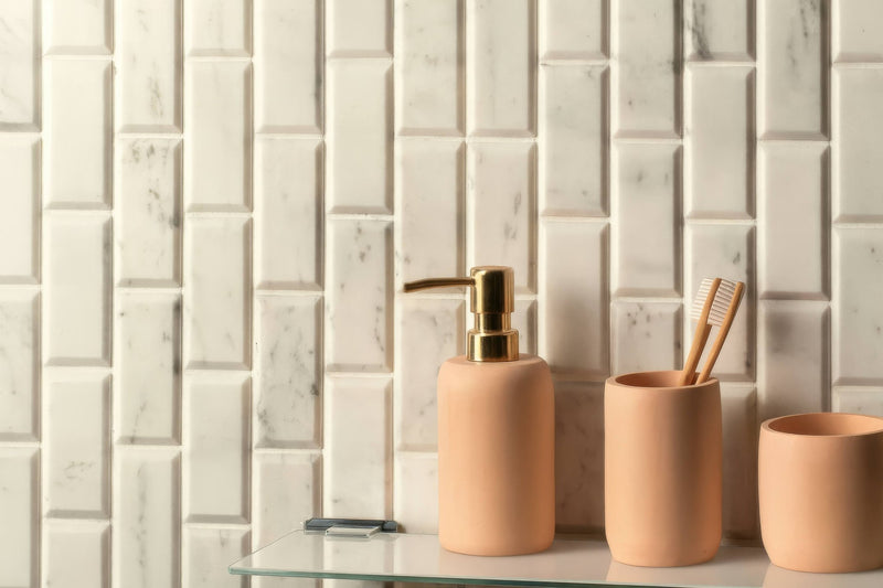Beige ceramic bathroom set with gold-tone pump dispenser and toothbrush holder in brickbond mosaic collection