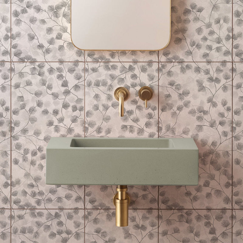 A sleek matte sage green concrete sink with minimalist rectangular design and polished brass fixtures from Canopy collection
