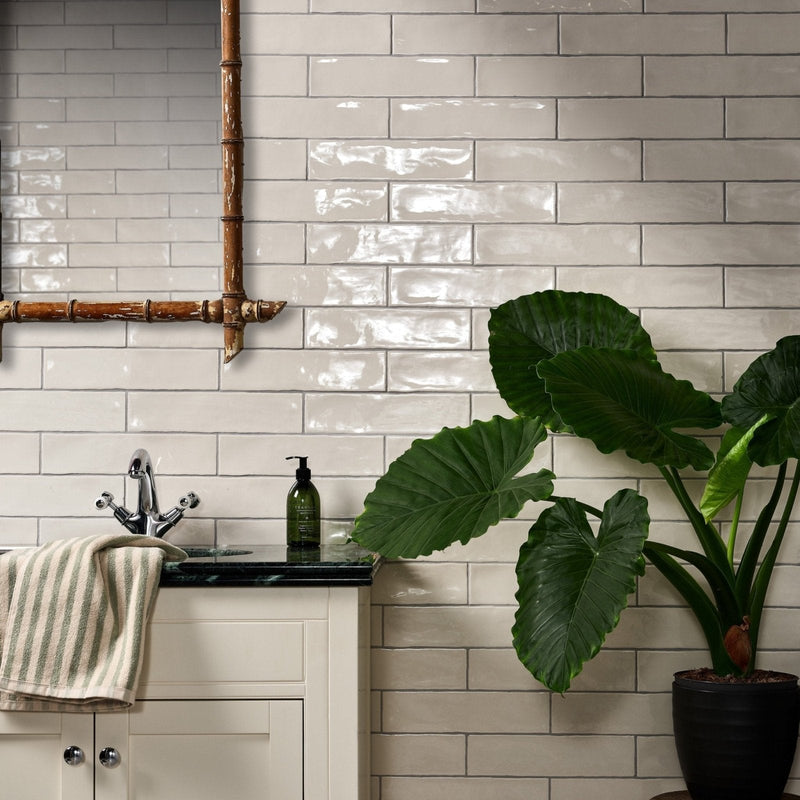 White glossy ceramic subway tiles with subtle sheen arranged horizontally in classic pattern from carter ceramic collection
