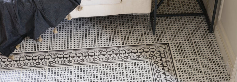 Black and white patterned casino tiles with intricate geometric designs on a ceramic floor surface