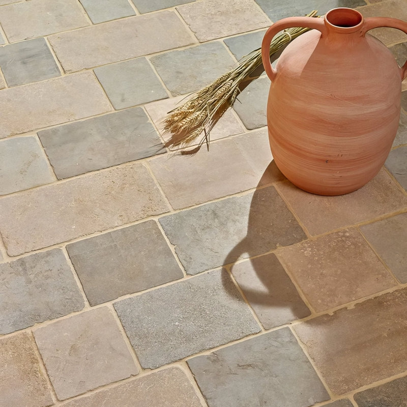 Terracotta ceramic jug with two handles and a bundle of wheat beside it in castilan limestone collection