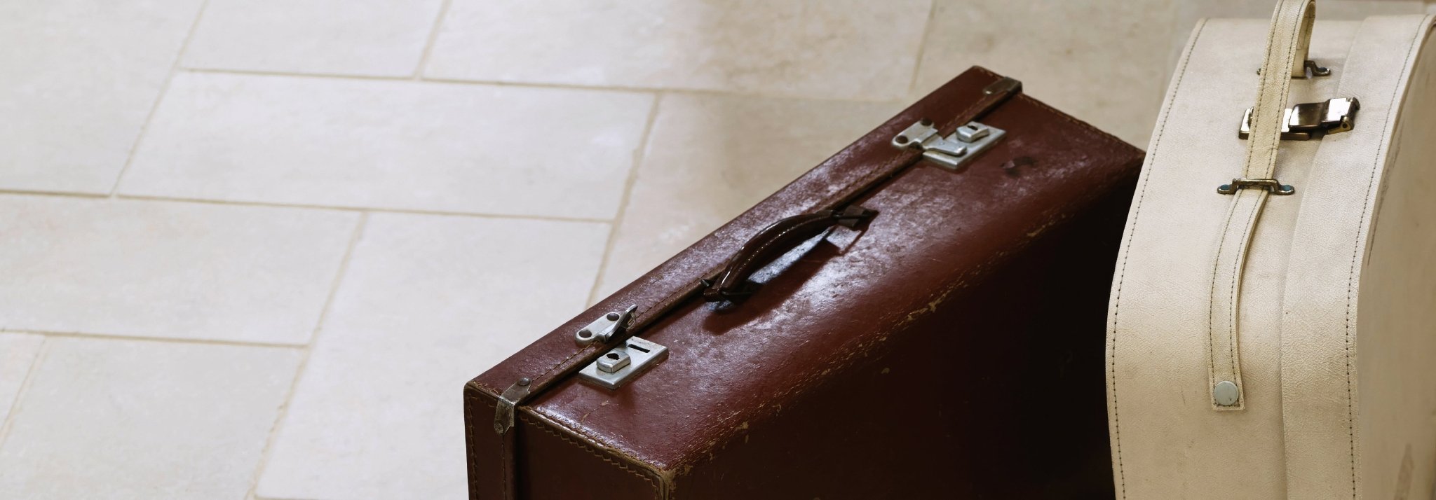 Vintage brown leather suitcase with silver metal clasps and handle from the Cathedral Limestone collection.