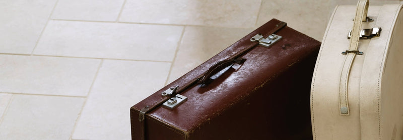 Vintage brown leather suitcase with silver metal clasps and handle from the Cathedral Limestone collection.