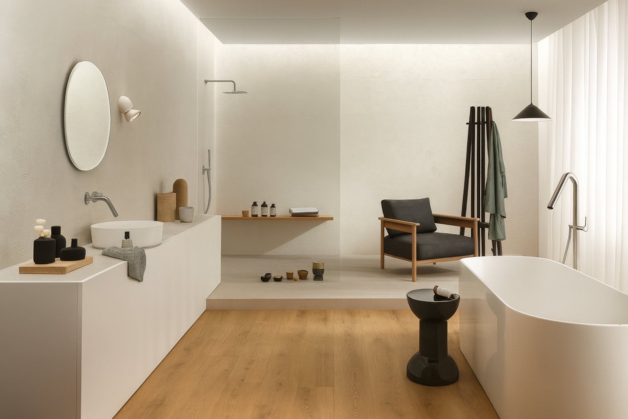 White freestanding bathtub with sleek minimalist design and smooth curved edges in ceramic bathroom tiles collection