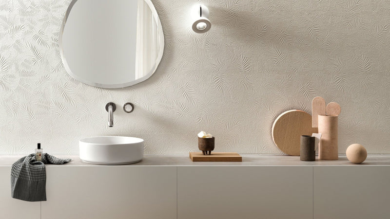White ceramic vessel sink with sleek minimalist design and modern chrome faucet in ceramic wall tiles collection