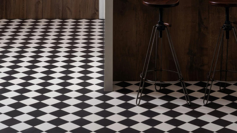 Black and white diamond patterned chequerboard floor tiles with a glossy finish for stylish interiors