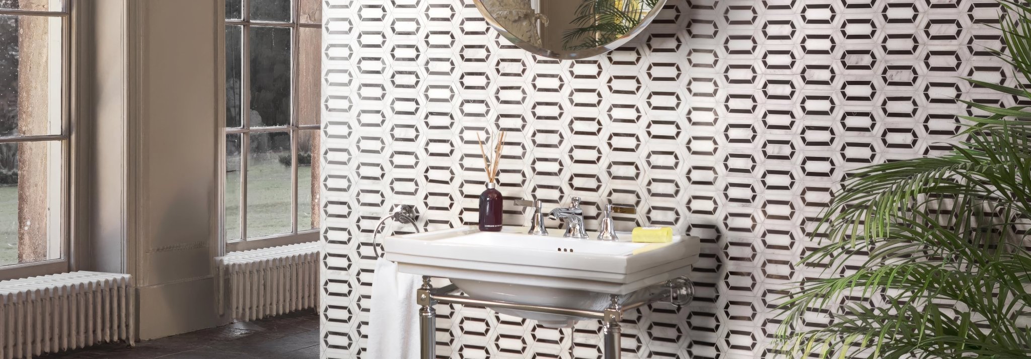 White ceramic pedestal sink with chrome fixtures and towel from chequers court collection displayed in bathroom setting