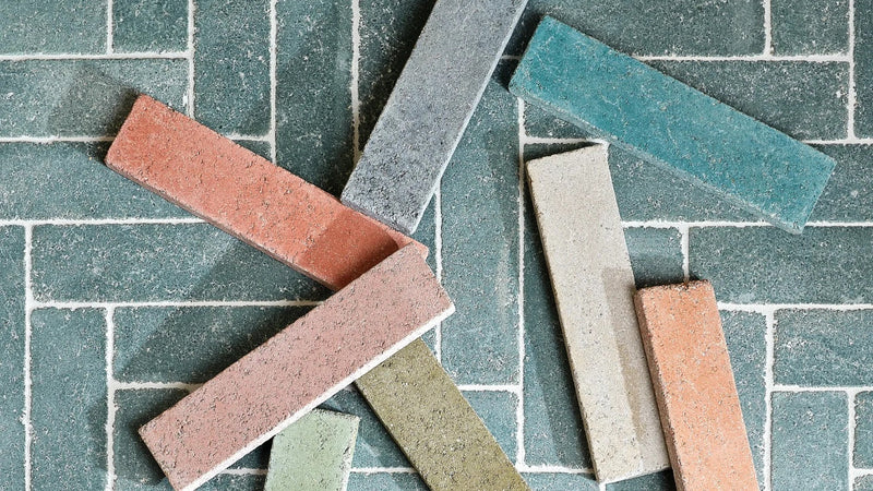 A collection of rectangular textured bricks in terracotta red gray teal green and beige from end of line tiles clearance