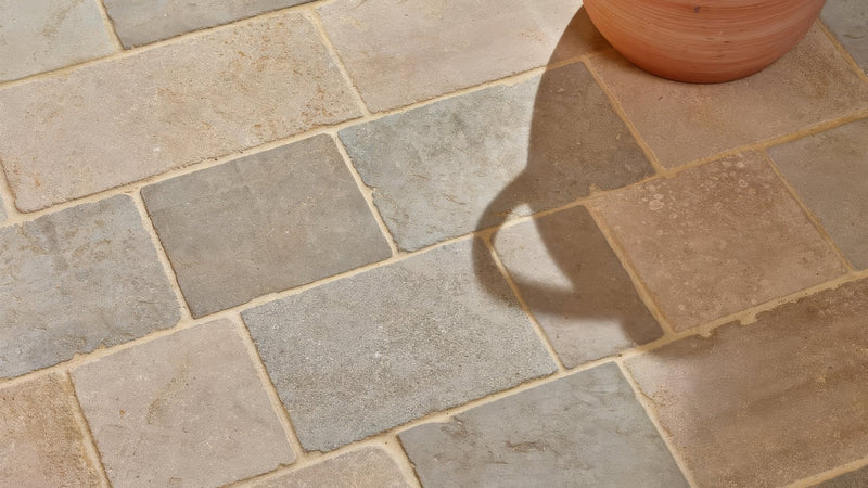Terracotta pot with rounded tapered shape and natural texture in a cobblestone kitchen tiles collection.