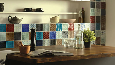 Colorful mosaic tile backsplash with geometric patterns in blue red brown and teal from the Colour Tiles collection