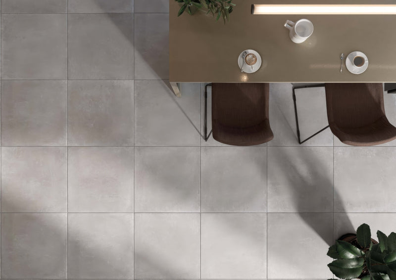 Gray matte-finish square floor tiles with a concrete effect ideal for bathroom flooring and modern interiors