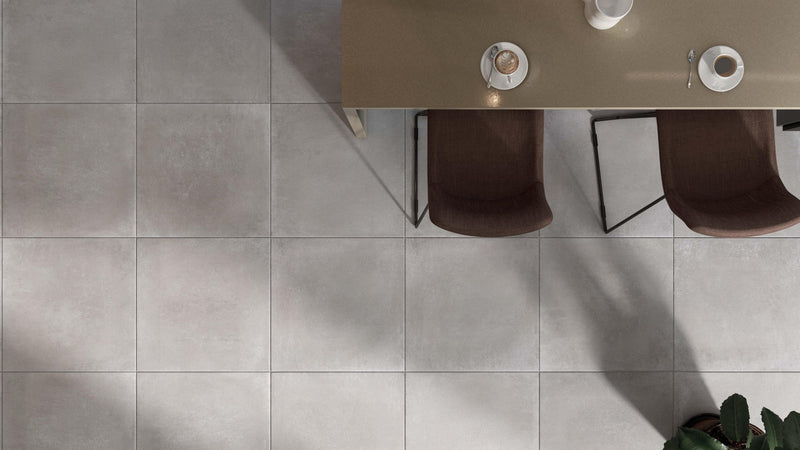 Gray matte-finish ceramic floor tiles with subtle texture and uniform square shape from concrete effect kitchen tiles collection