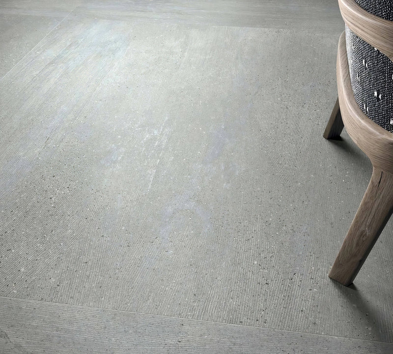Gray concrete effect floor tile with subtle texture and speckled finish in concrete effect tiles collection