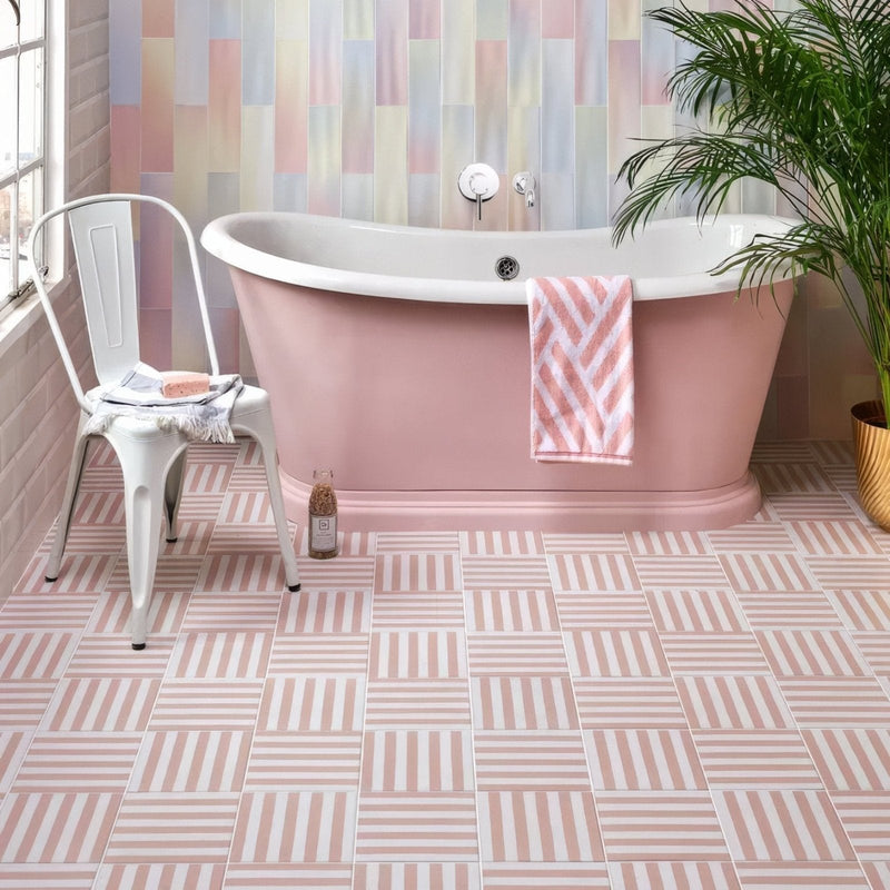 Pink freestanding bathtub with white porcelain interior and chrome fixtures from the deck chair porcelain collection