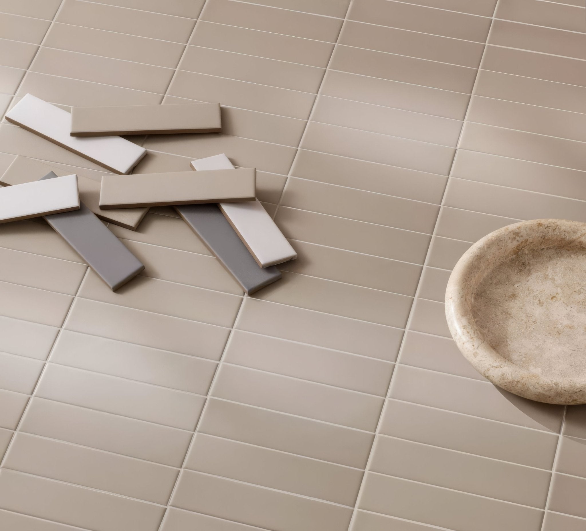 Beige rectangular subway tiles with a matte finish arranged in a grid pattern from the Designers collection