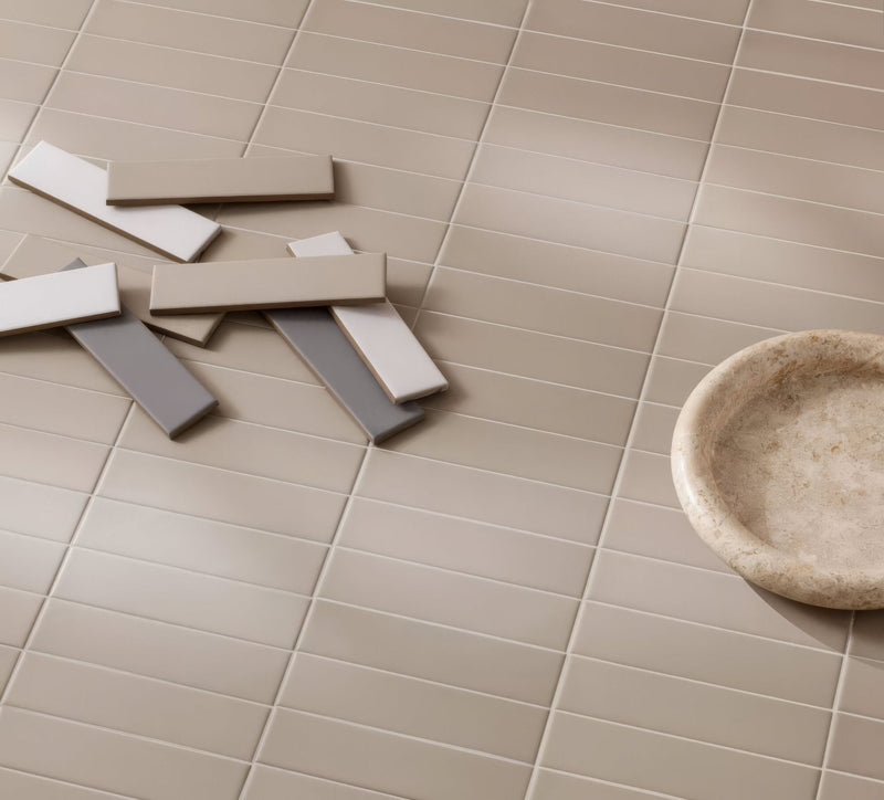 Beige rectangular subway tiles with a matte finish arranged in a grid pattern from the Designers collection