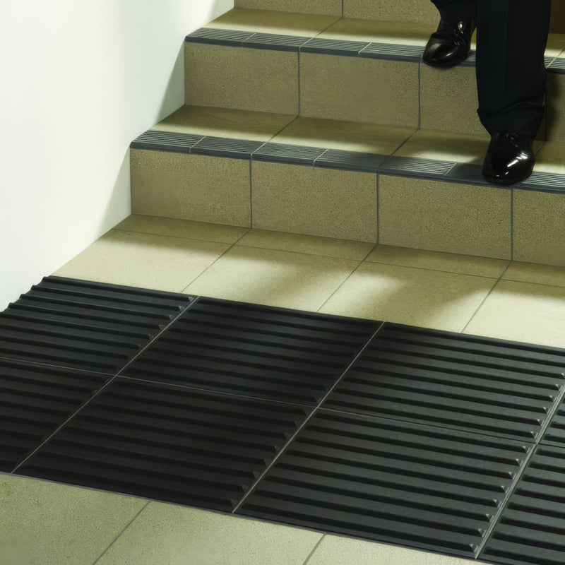Black rubber anti-slip stair mat with ribbed texture from dorset woolliscroft tactile curdoroy collection
