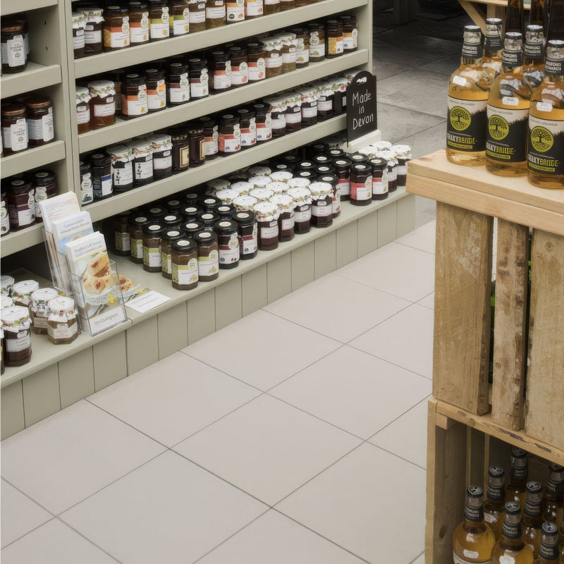 Rows of glass jars filled with dark and light preserves on shelves in a store aisle from Dorset Woolliscroft textured collection.