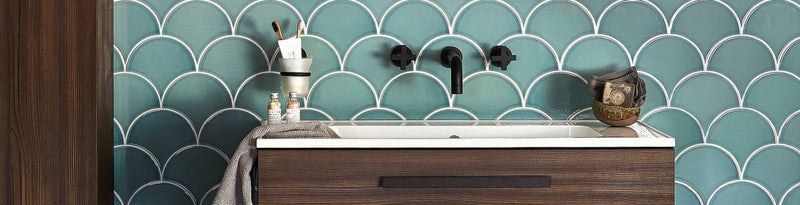 Teal scalloped tile backsplash with white outlines from the Escalas Tiles collection for wall decoration.