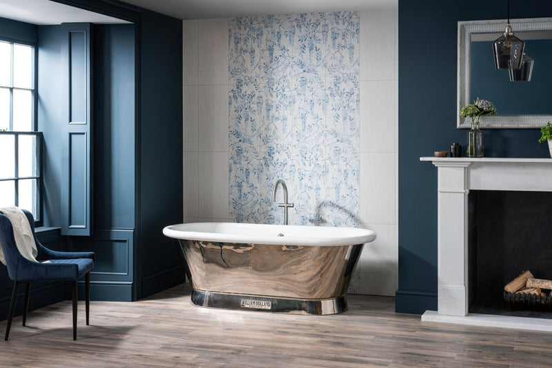 Polished copper freestanding bathtub with sleek oval shape and chrome faucet featured with decorative wall tiles