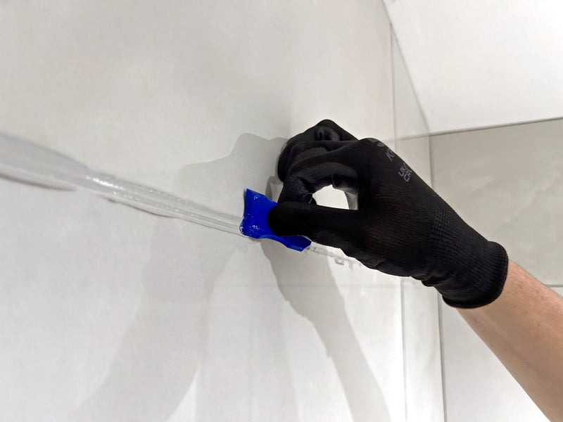 Blue plastic tile spacers used to separate white tiles in fixing and grouting materials collection