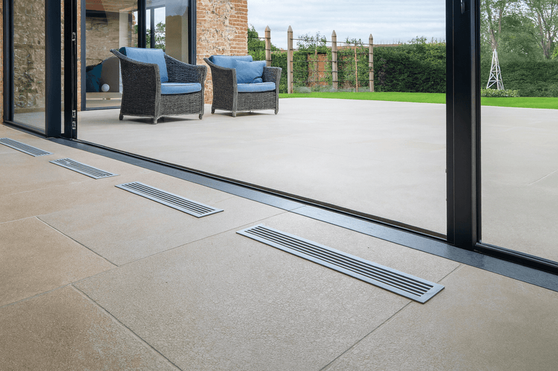 Silver metallic floor vents with sleek modern design featured in flagstone floor tiles collection