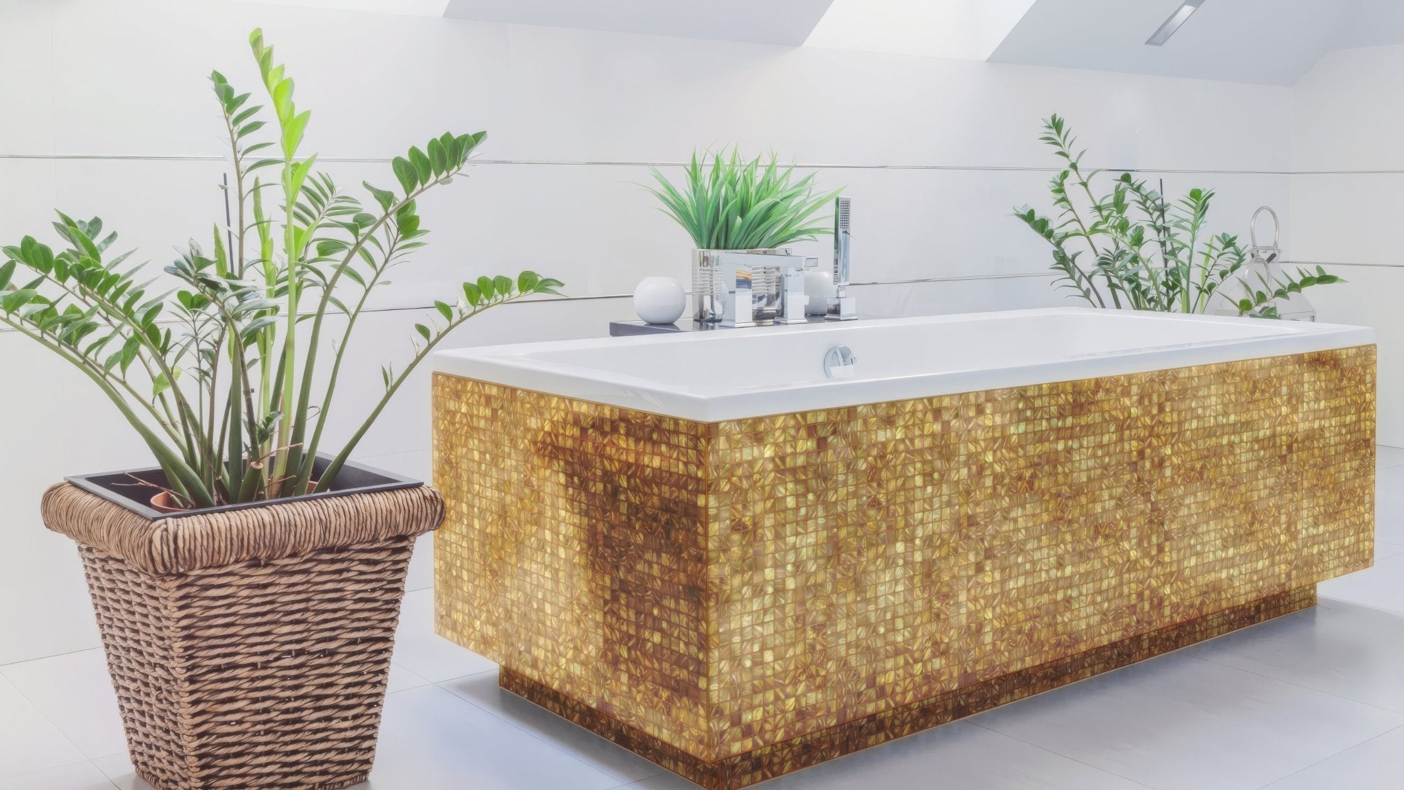 Golden mosaic tiled bathtub with sleek white interior and modern chrome fixtures in gold bathroom tiles collection