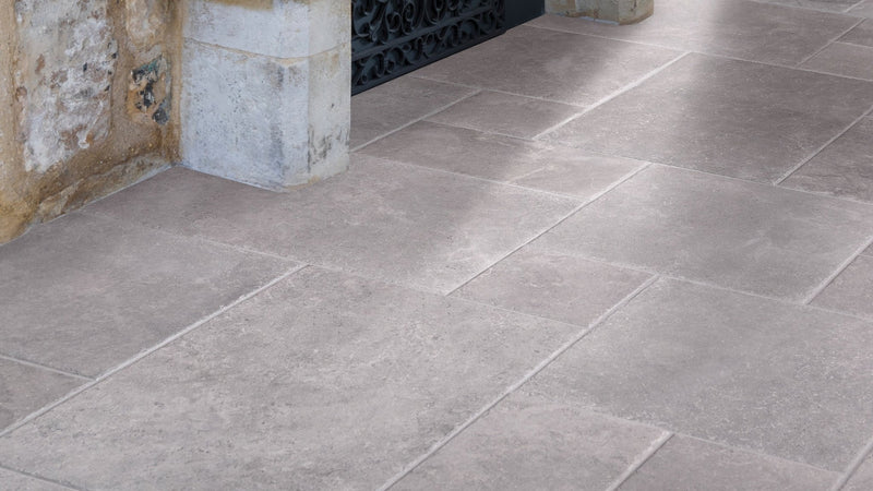 Gray stone tiles with subtle texture and natural tone variations laid out as an elegant floor in grey floor tiles collection