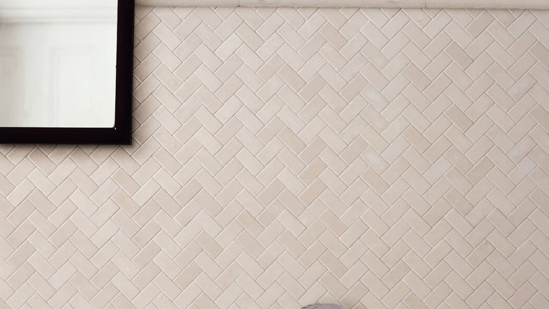 Beige herringbone patterned ceramic subway tiles ideal for bathroom walls in the herringbone bathroom tiles collection