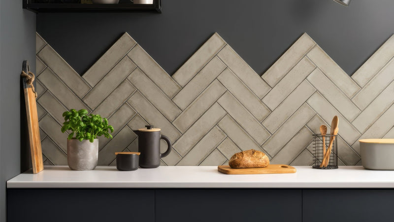 Gray herringbone patterned ceramic kitchen backsplash tiles from the herringbone wall tiles collection