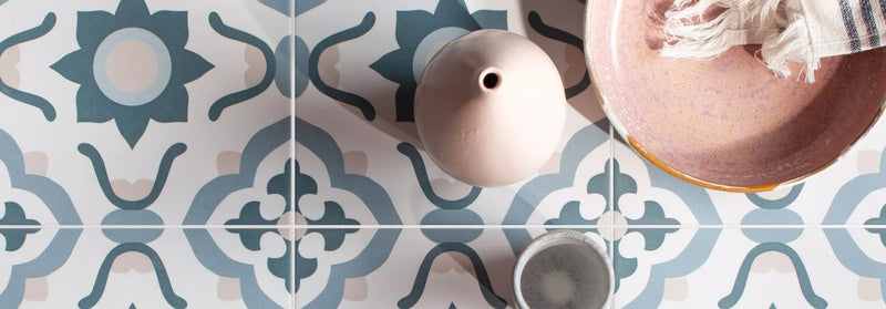 A blush pink matte ceramic vase with a rounded body and narrow neck from the infusion tile collection