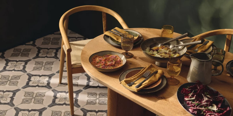 Wooden dining table with warm natural finish and rounded edges in the Jaipur Collection