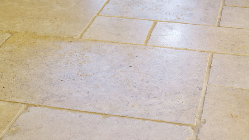 Beige limestone kitchen tiles with a subtle textured surface and natural variations in tone