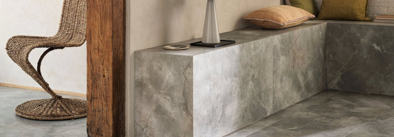 Gray marble bench with sleek modern design and subtle veining from the lux marble effect porcelain collection