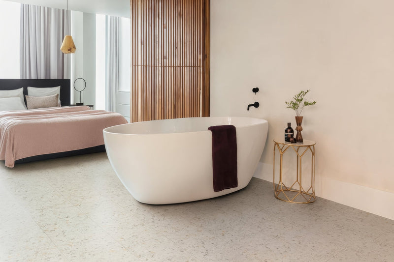 Free-standing white bathtub with sleek modern design and glossy finish in lvt bathroom tiles collection