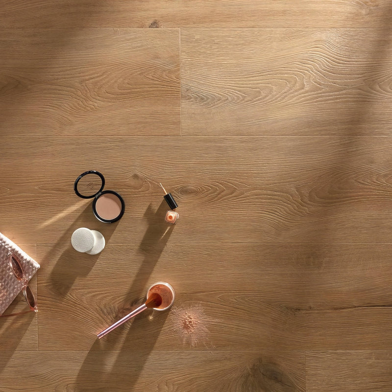 A beige compact powder with black lid and white cap resting on a wooden surface in an LVT flooring collection