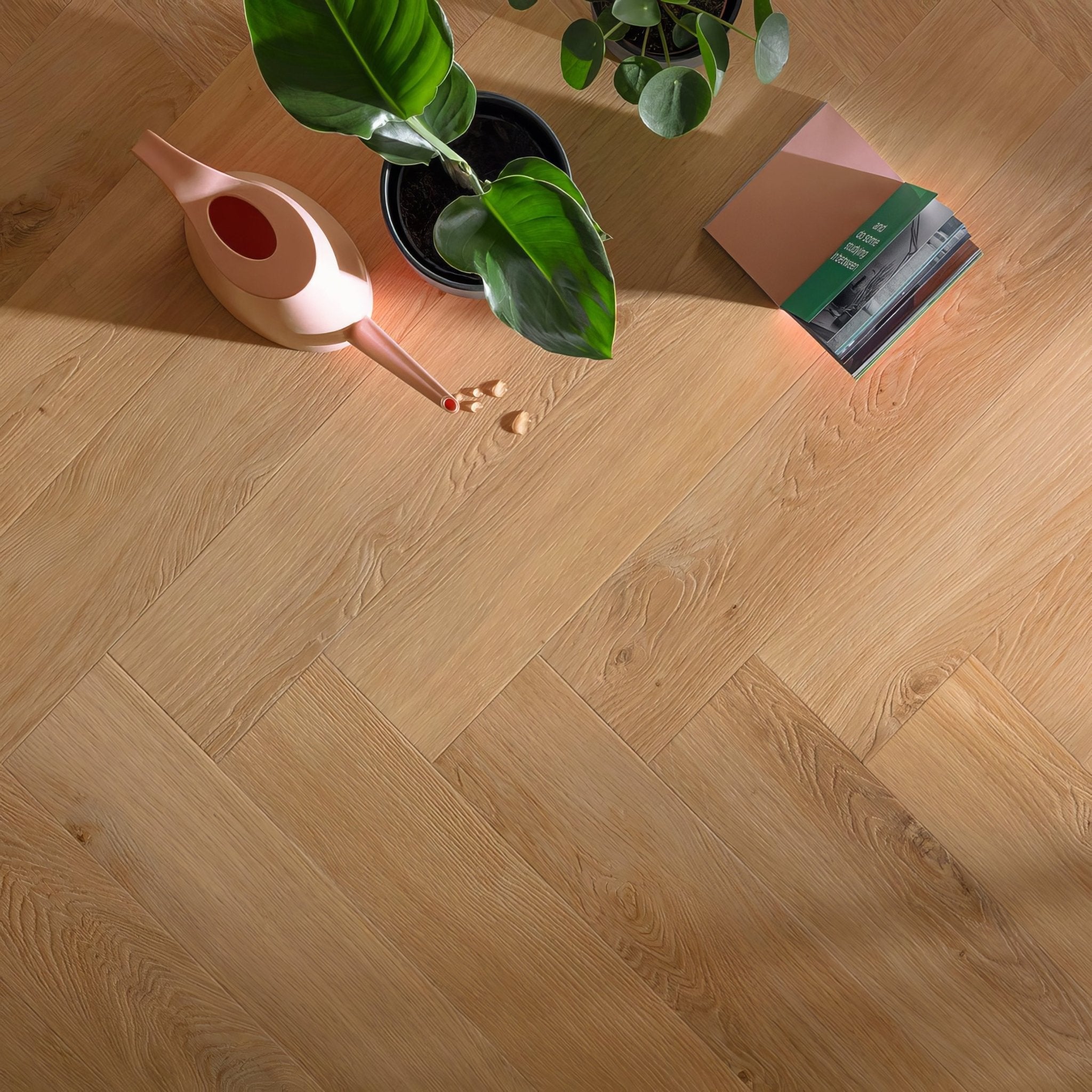 Light oak-colored hardwood floor with a herringbone pattern from luxury herringbone LVT rigid core parquet collections