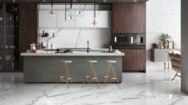 Modern kitchen island with sleek gray countertop and dark wood cabinetry featuring marble effect kitchen tiles