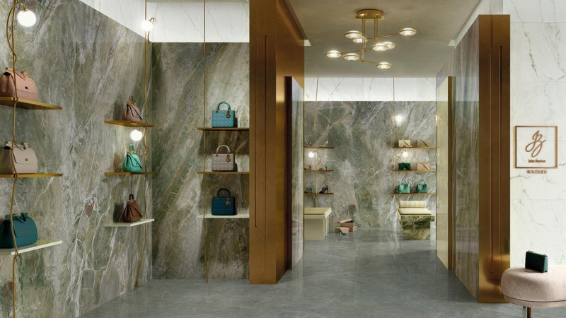 A collection of colorful handbags displayed on wooden shelves against a green marble effect wall tile backdrop