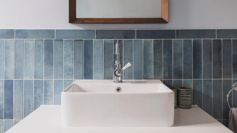 White rectangular sink with sleek chrome faucet against blue tiled backsplash in metro bathroom tiles collection