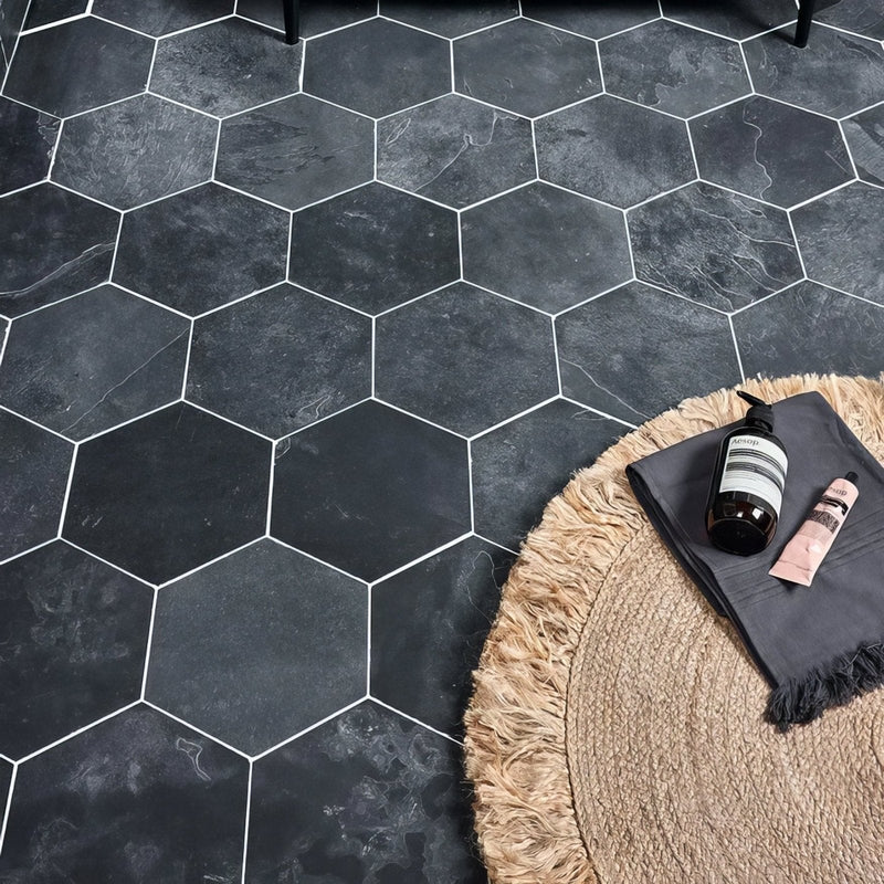 Dark gray hexagonal floor tiles with white grout lines from the metropolitan slate collection for modern interiors