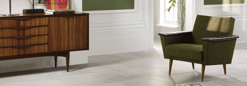Olive green upholstered armchair with wooden legs and black trim from the Montpellier Tile Collection