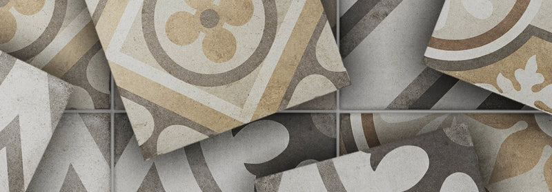 Patterned ceramic floor tiles in beige gray and cream with ornate circular and floral designs from naples tile collection