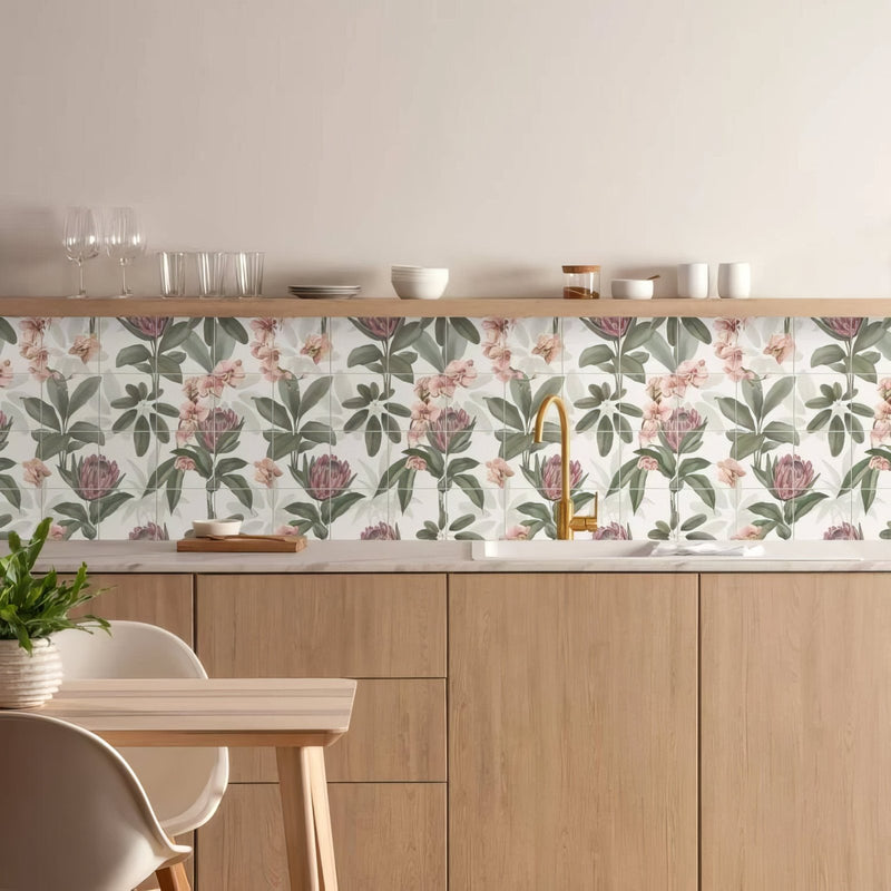 Floral-patterned kitchen backsplash tiles with soft pink and muted green botanical designs on a light background
